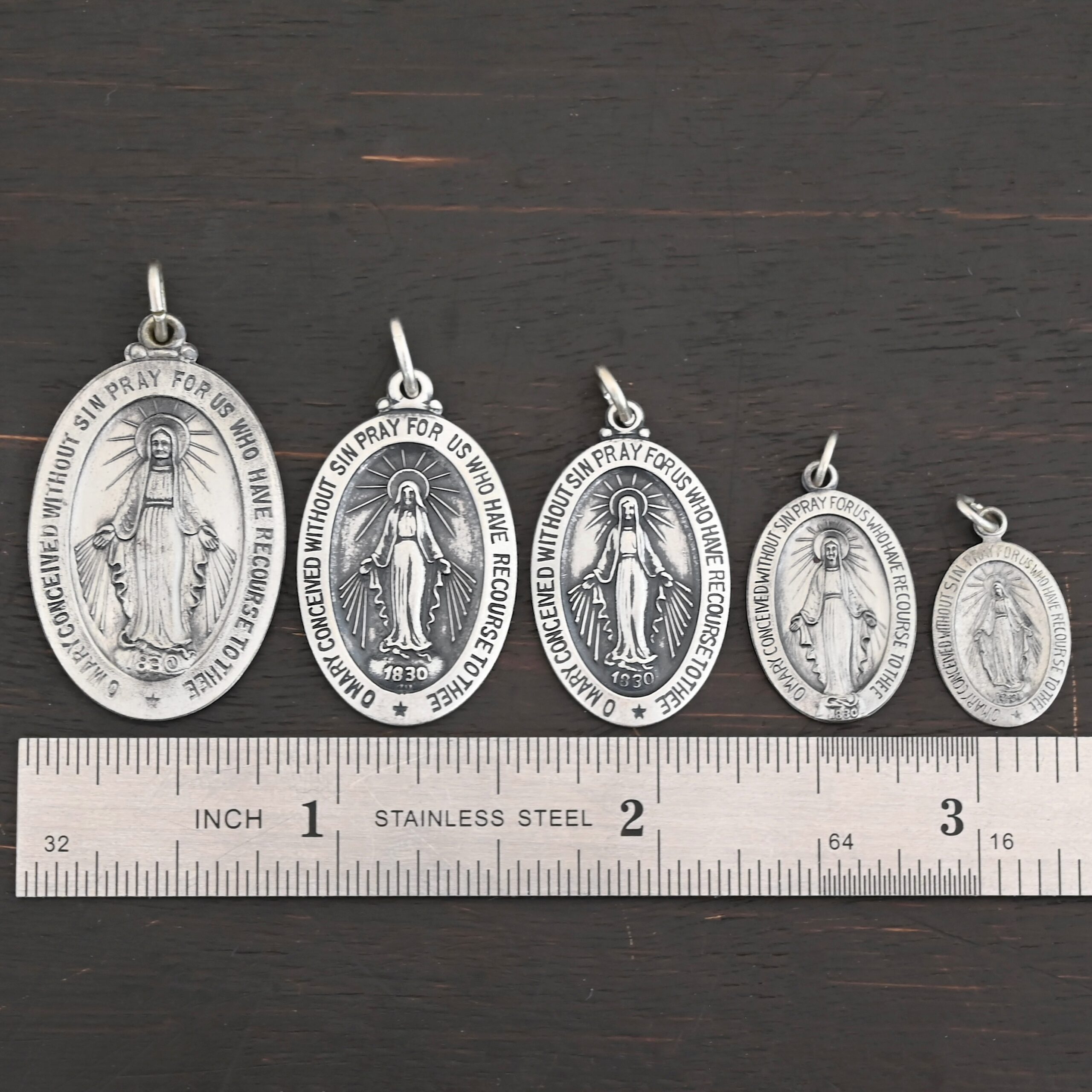 Mary Medallion Charm Silver Mary Medallion Oval Charms all sizes shown by ruler