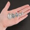 Silver Mary Medallion Oval Charms all sizes shown in hand