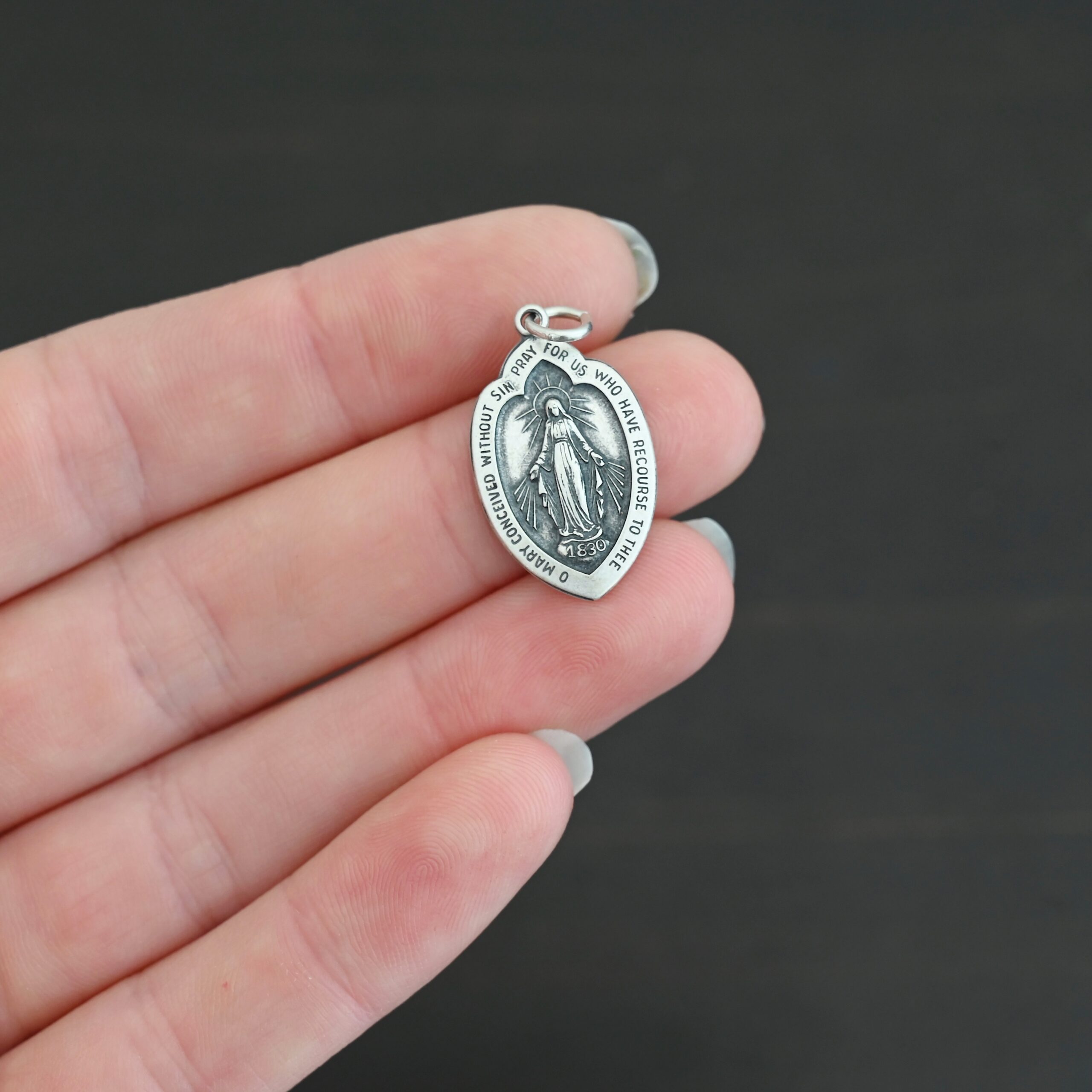 Silver Mary Medallion 26x15mm charm shown in hand