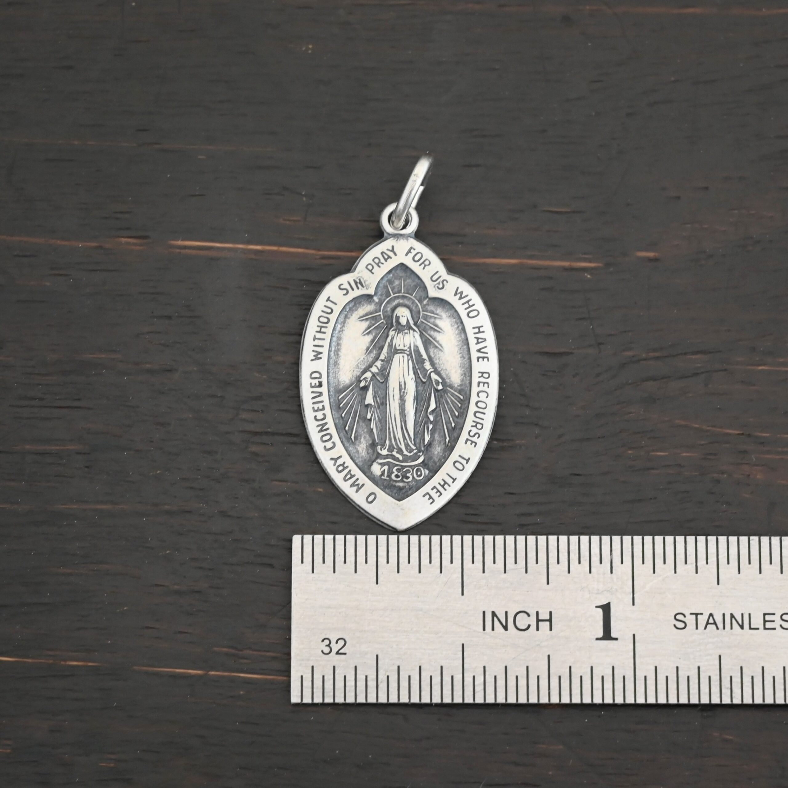 Silver Mary Medallion 26x15mm charm shown by ruler