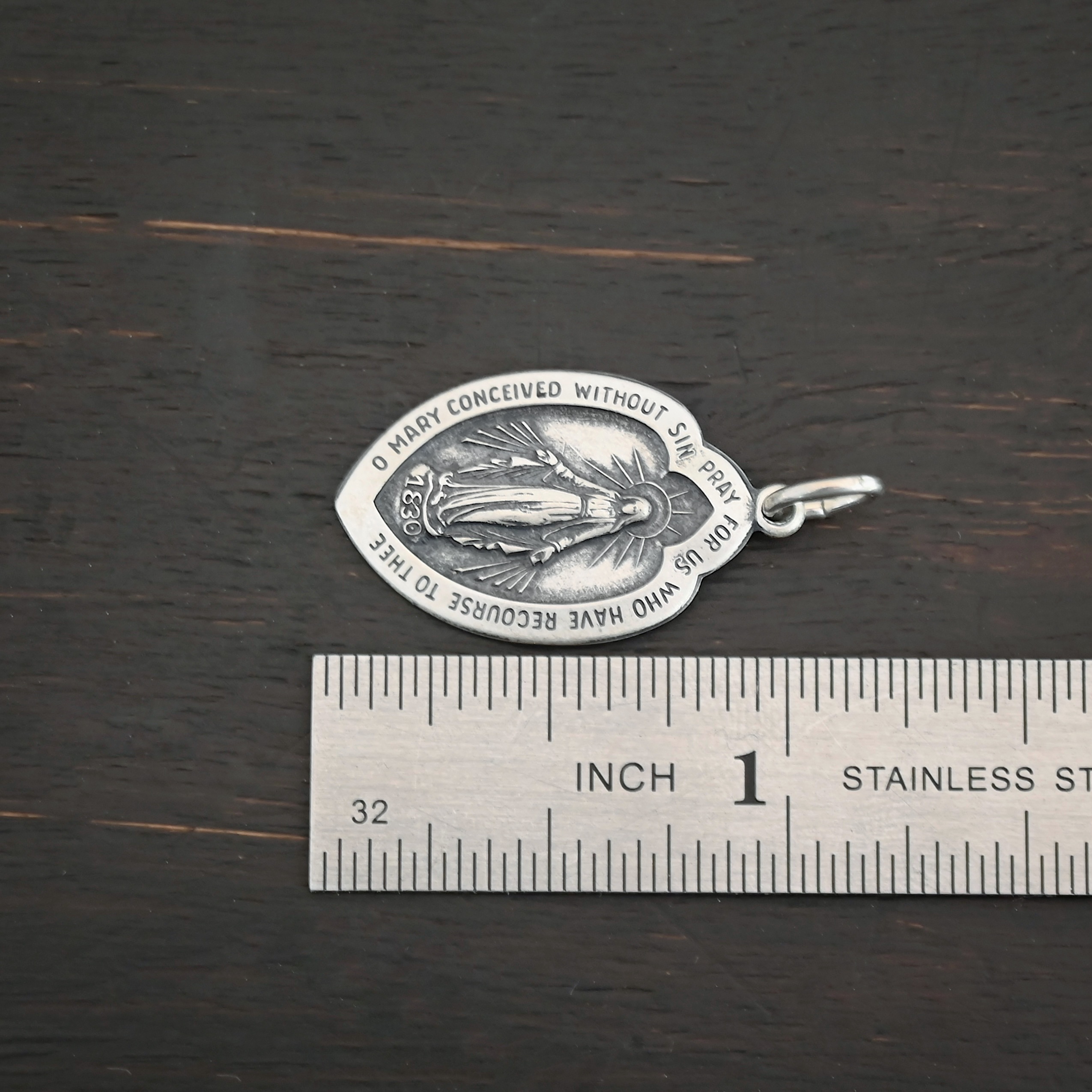 Silver Mary Medallion 26x15mm charm shown by ruler