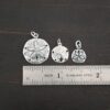 Silver Sand Dollar Charms shown by ruler