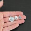 Silver Sand Dollar Charms shown in hand