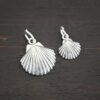 Silver Sea Shell Charms shown on dark background