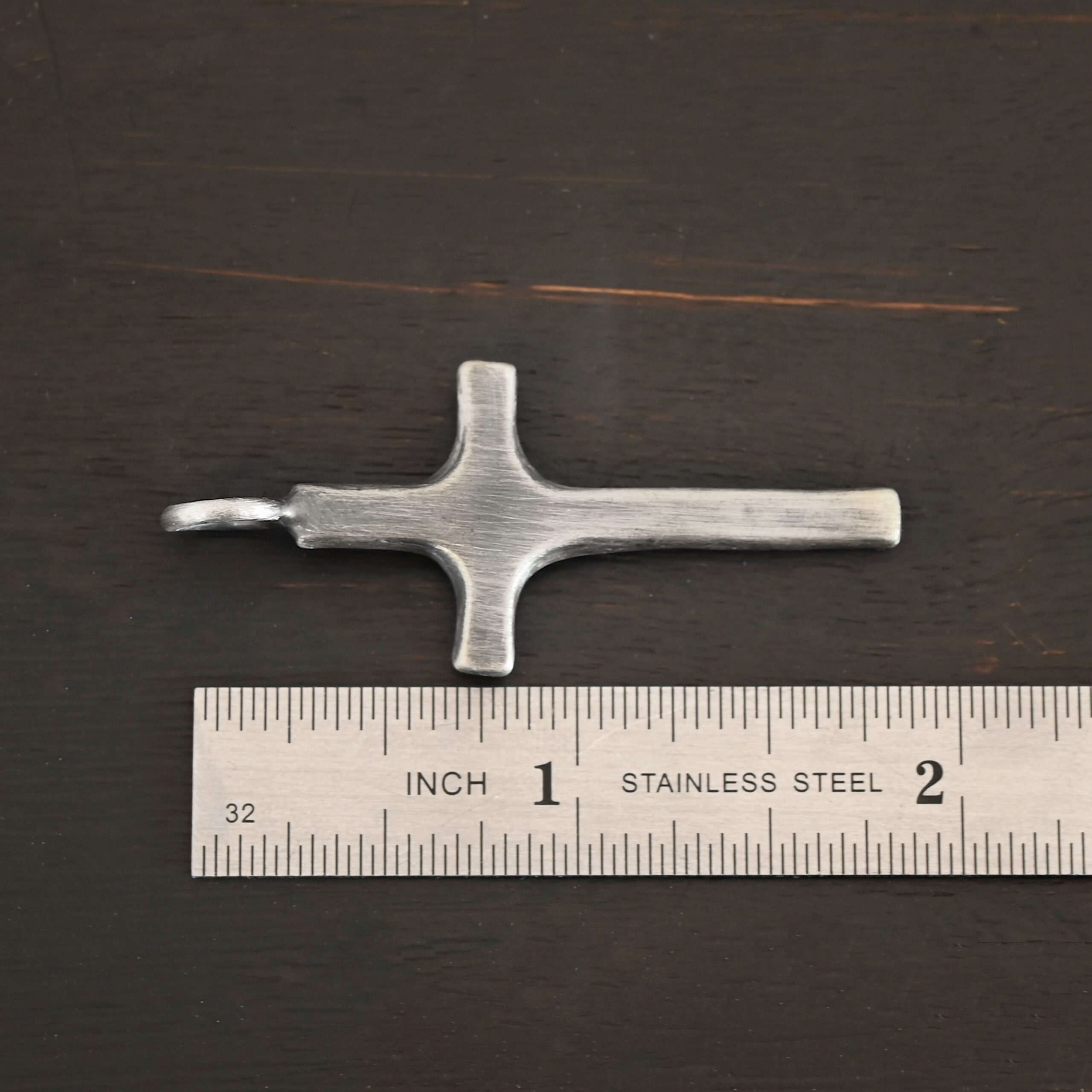 Silver large Cross pendant oxidized shown by ruler