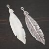 Silver Feather charm shiny & oxidized charm shown on dark background