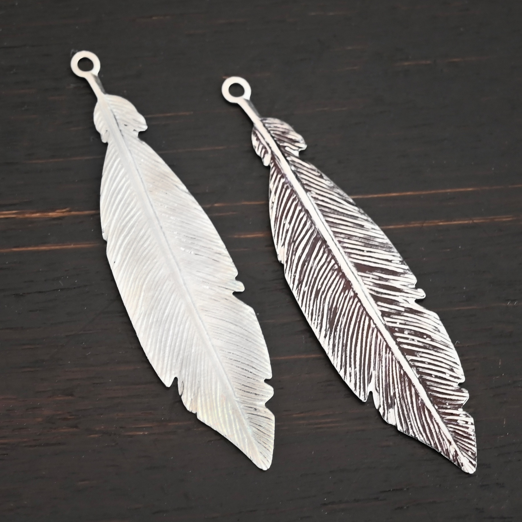 Feather Charm Silver Feather charm shiny & oxidized charm shown on dark background