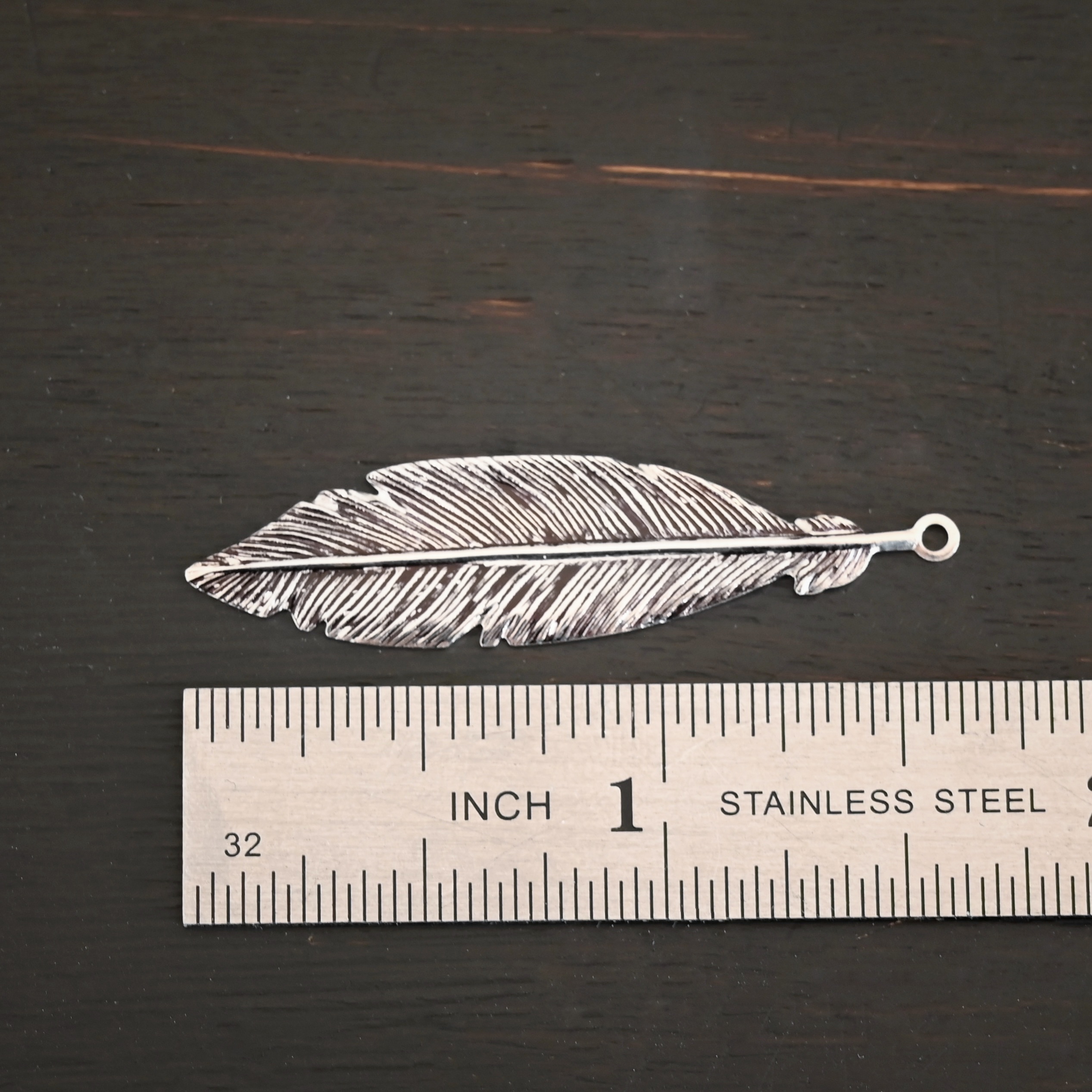 Feather Charm - ox Silver Feather charm oxidized charm shown by ruler