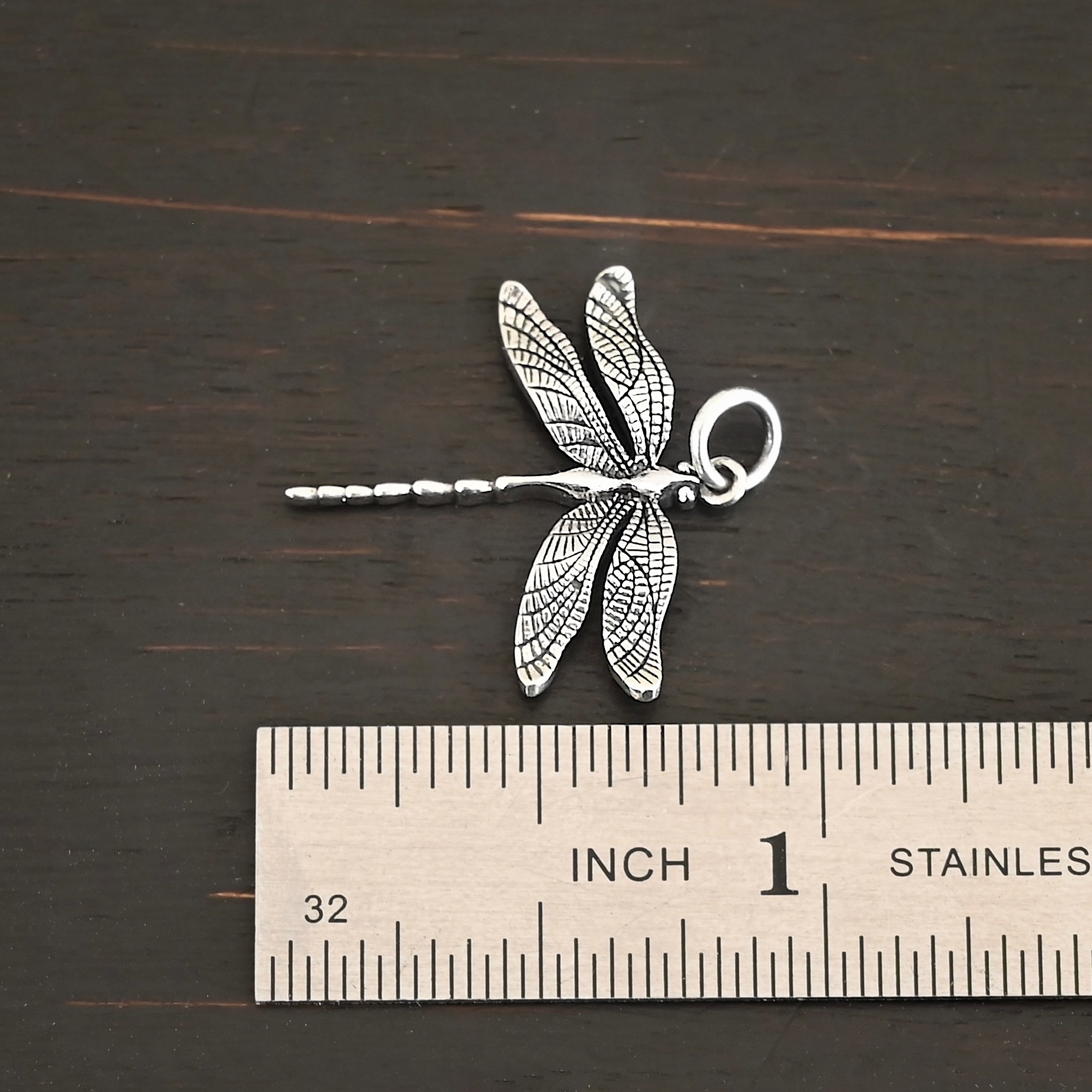 Silver Dragonfly charm shiny charm shown by ruler