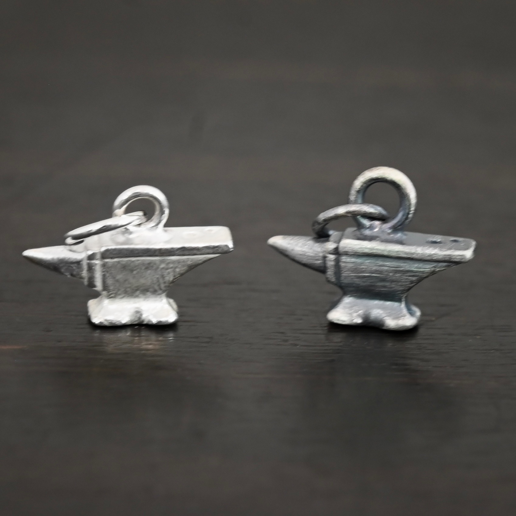 Silver anvil charm shiny & oxidized shown on dark background