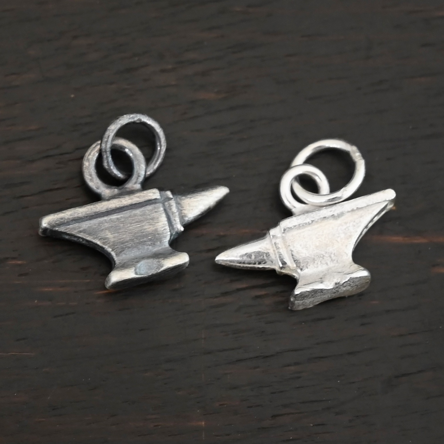Silver anvil shiny & oxidized charm shown on dark background