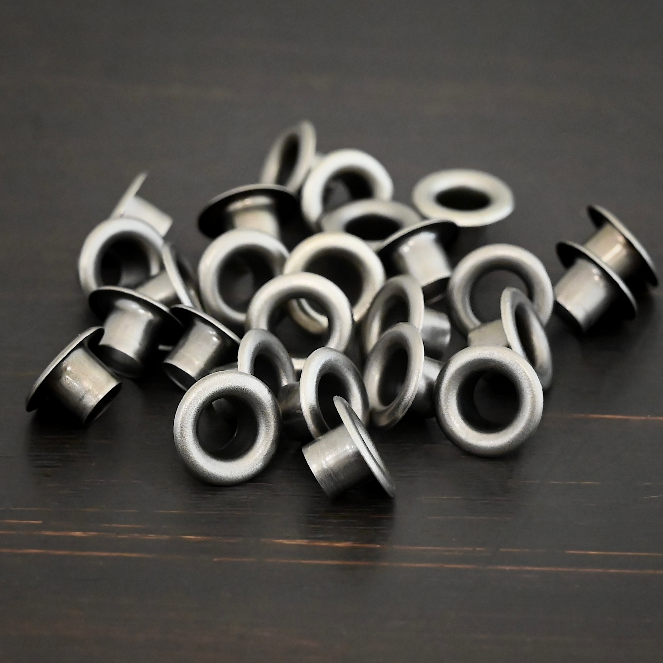 Large Bronze Grommets shown on dark background