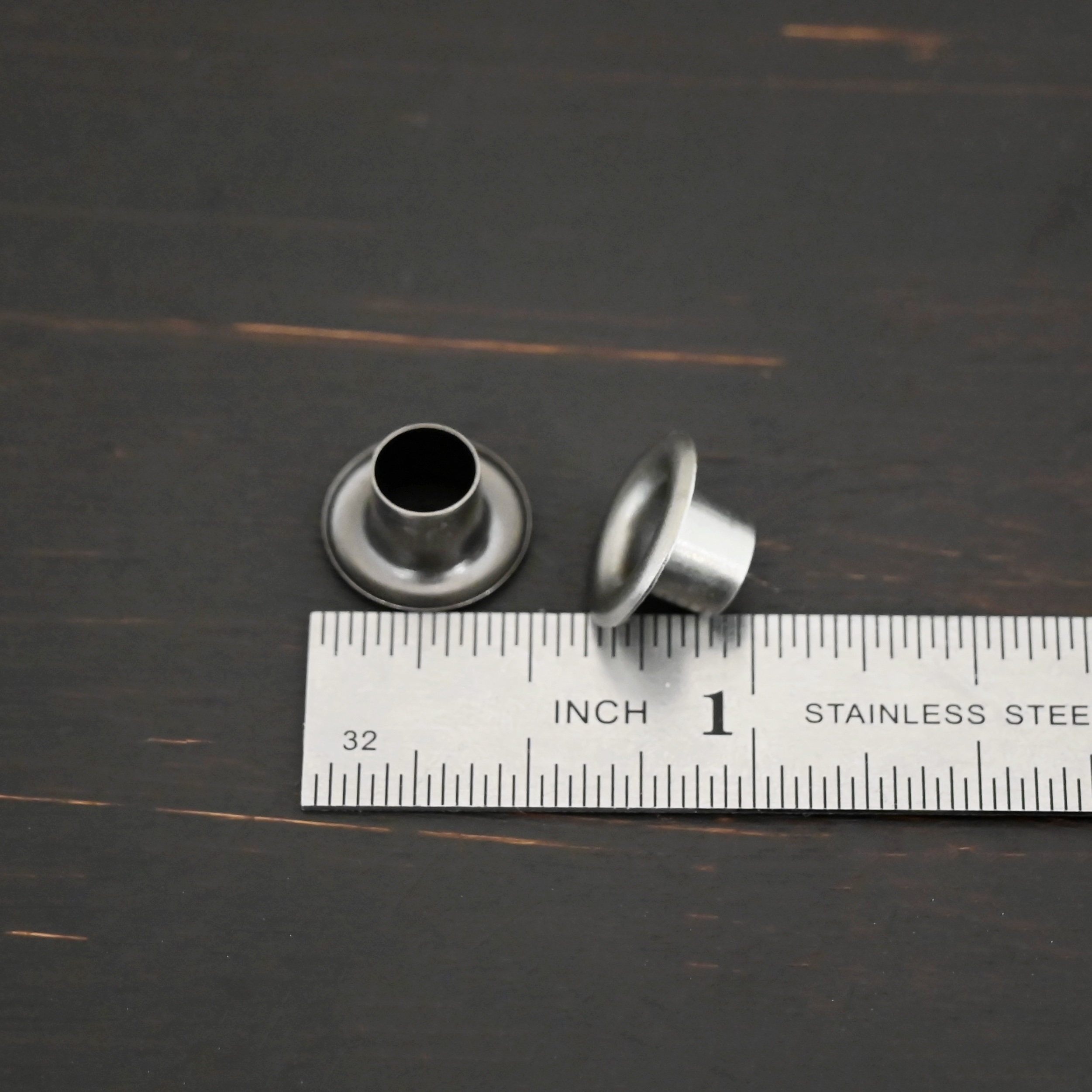 Large Bronze Grommets shown by ruler