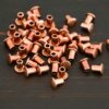 Copper Rivets shown on dark background