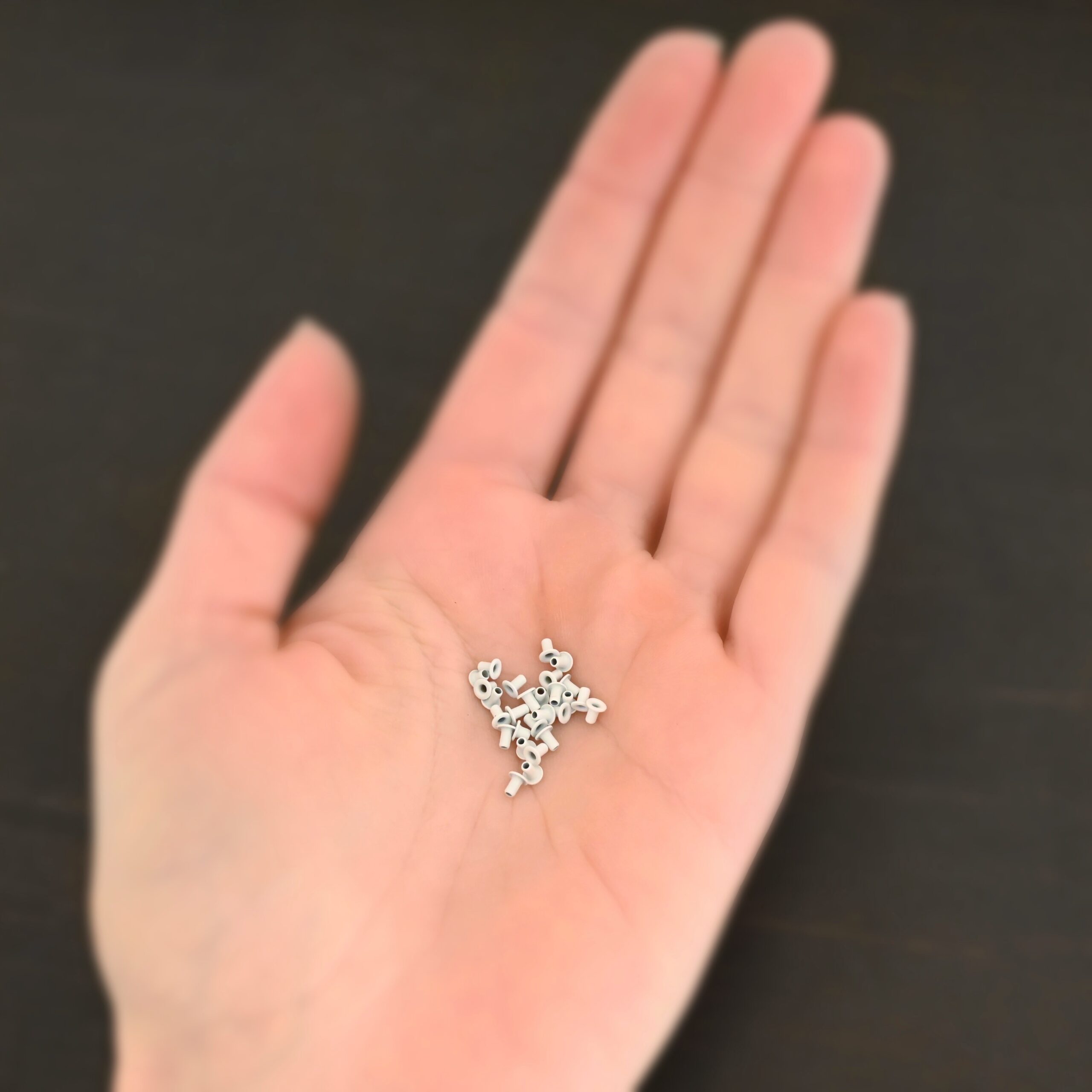 EZ Riveter 1/16x3/32 - White 1/16x3/32 white eyelets for EZ Riveter shown in hand