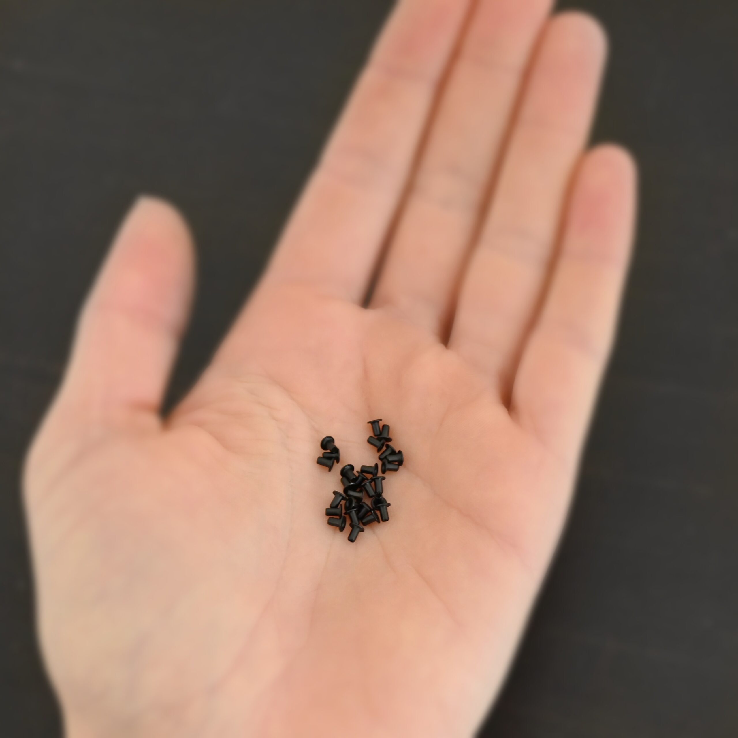 EZ Riveter 1/16x3/32 - Black 1/16x3/32 black eyelets for EZ Riveter shown in hand