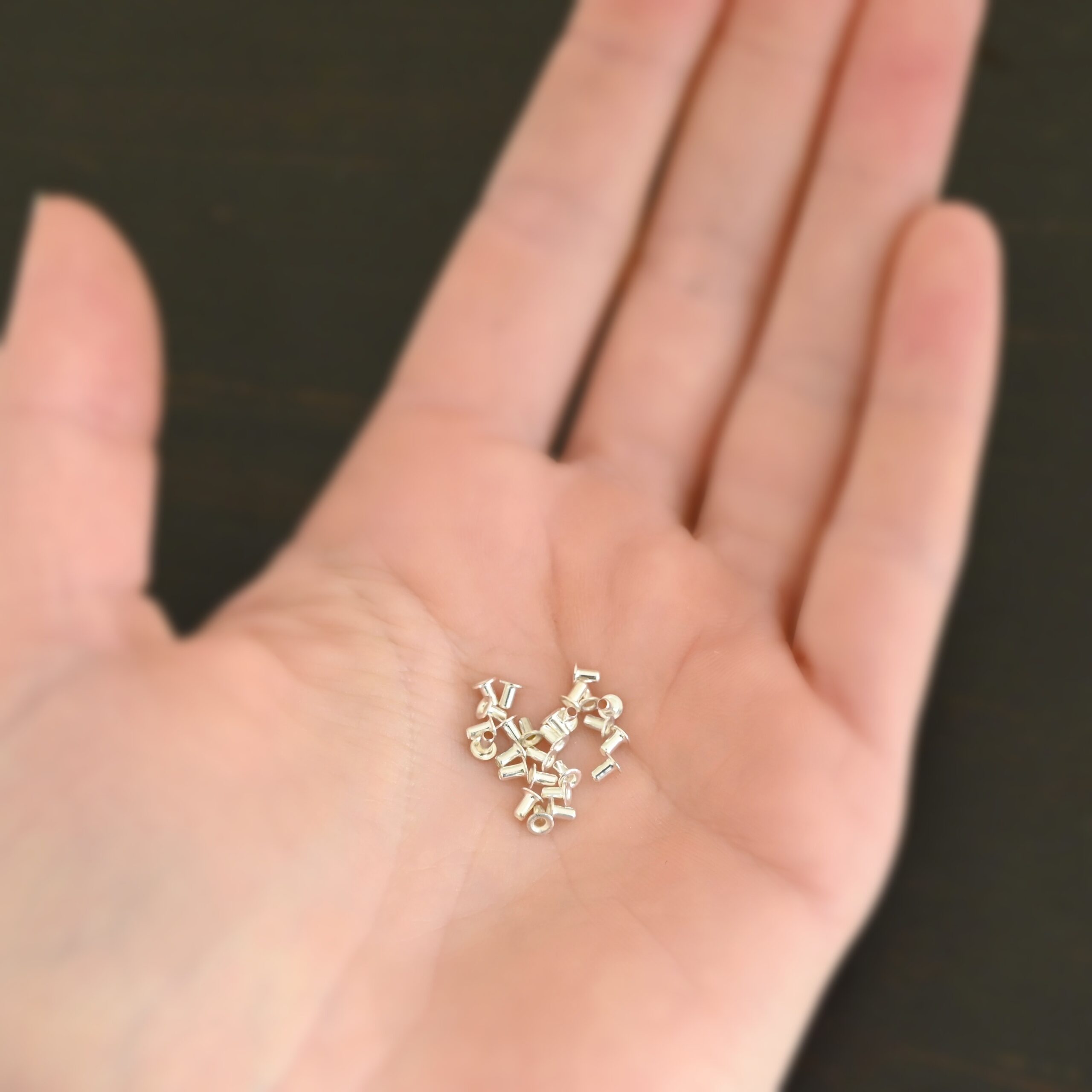 EZ Riveter 1/16x3/32 - Silver 1/16x3/32 silver eyelets for EZ Riveter shown in hand