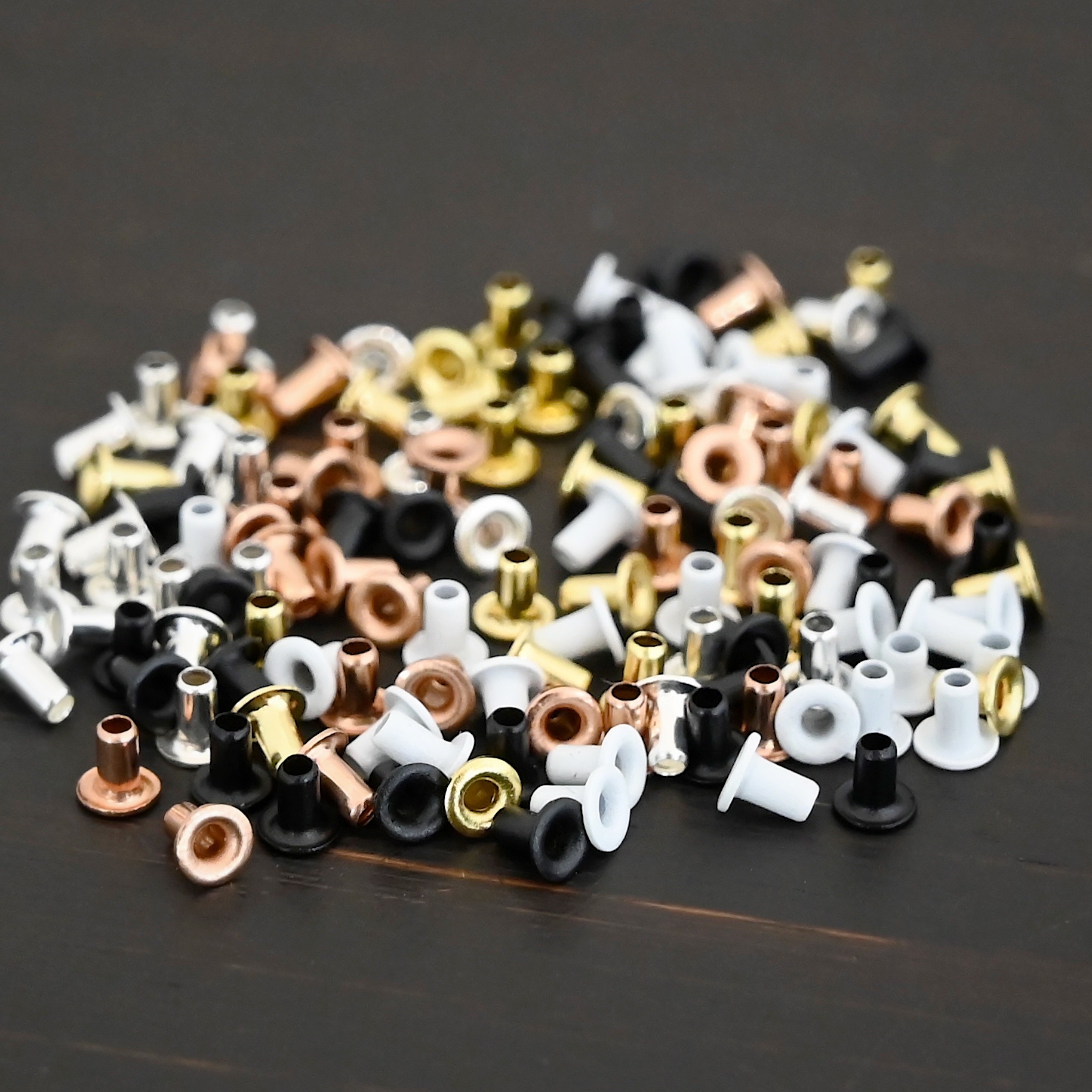 EZ Riveter 1/16x3/32 1/16x3/32 eyelets for EZ Riveter shown on dark background