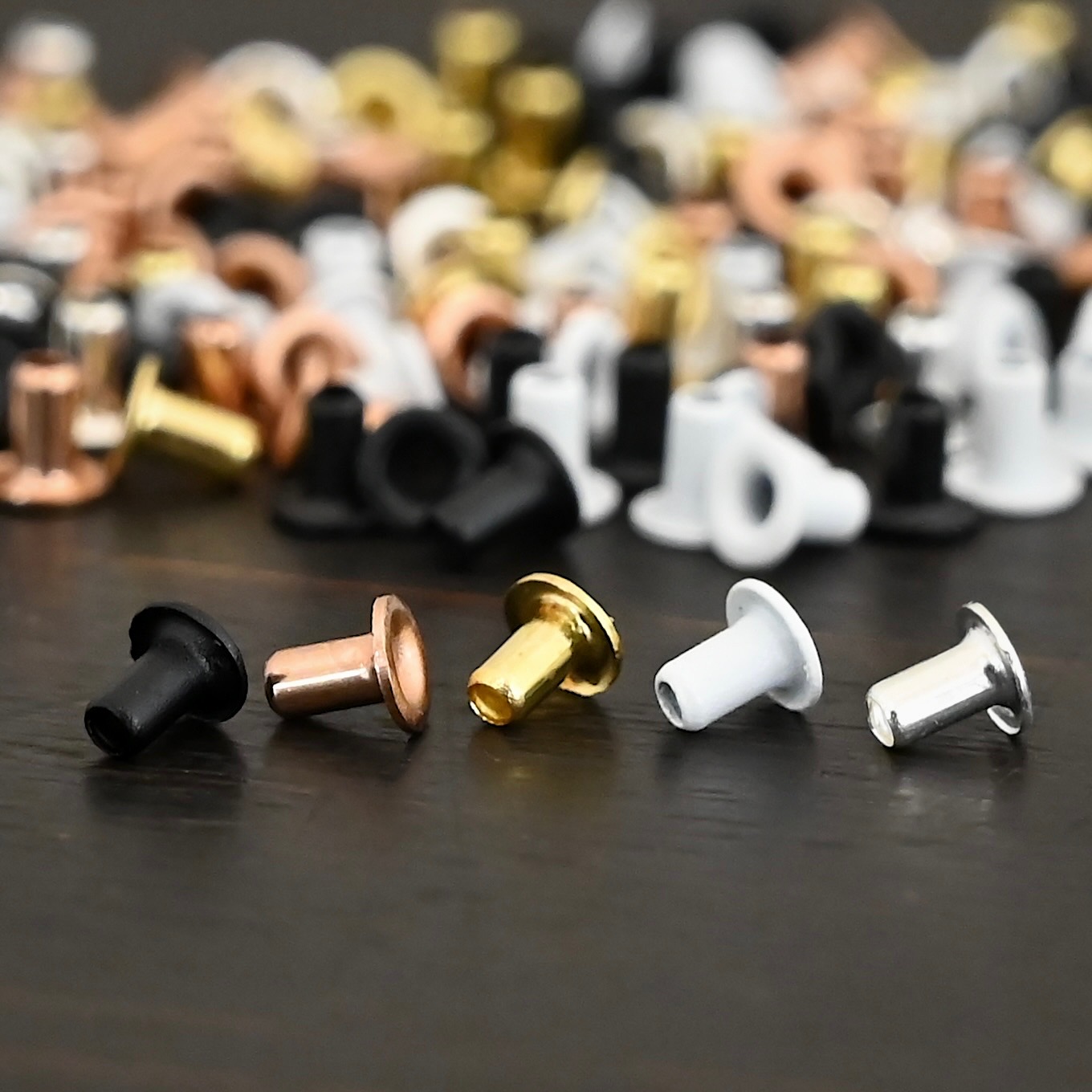 EZ Riveter 1/16x3/32 1/16x3/32 eyelets for EZ Riveter shown on dark background