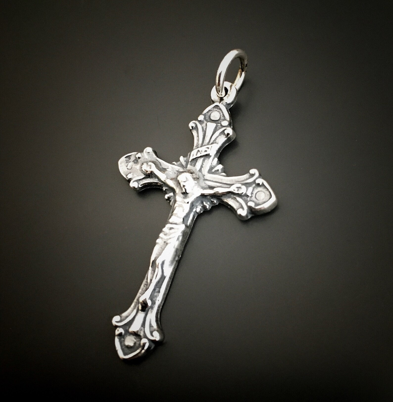 Silver Crucifix Pendant shown on dark background