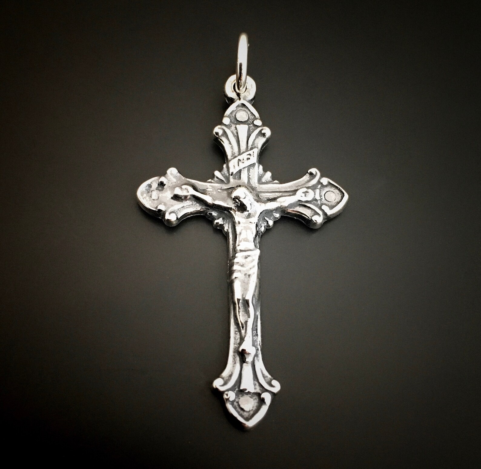 Silver Crucifix Pendant shown on dark background