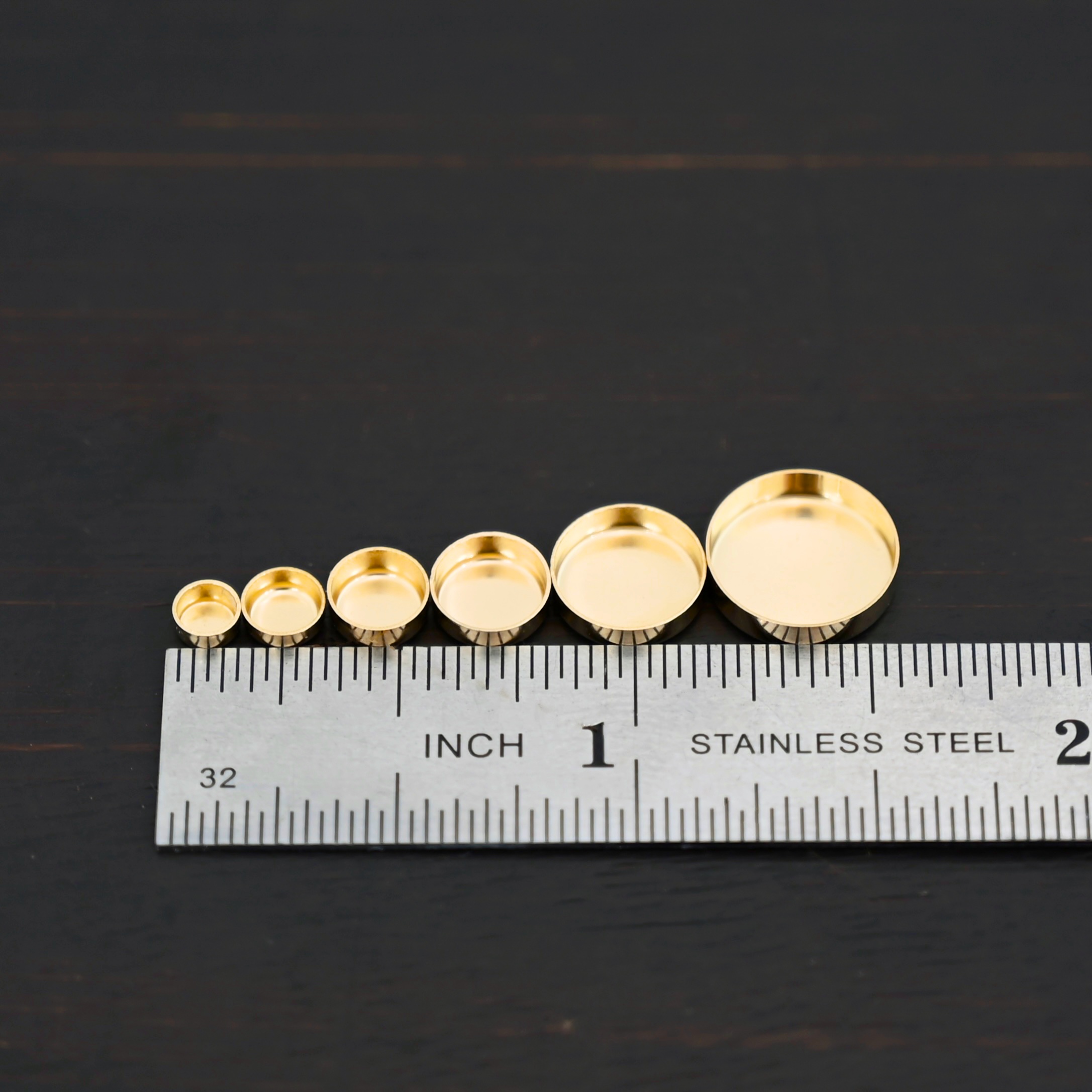 14k gold bezel cups shown by ruler