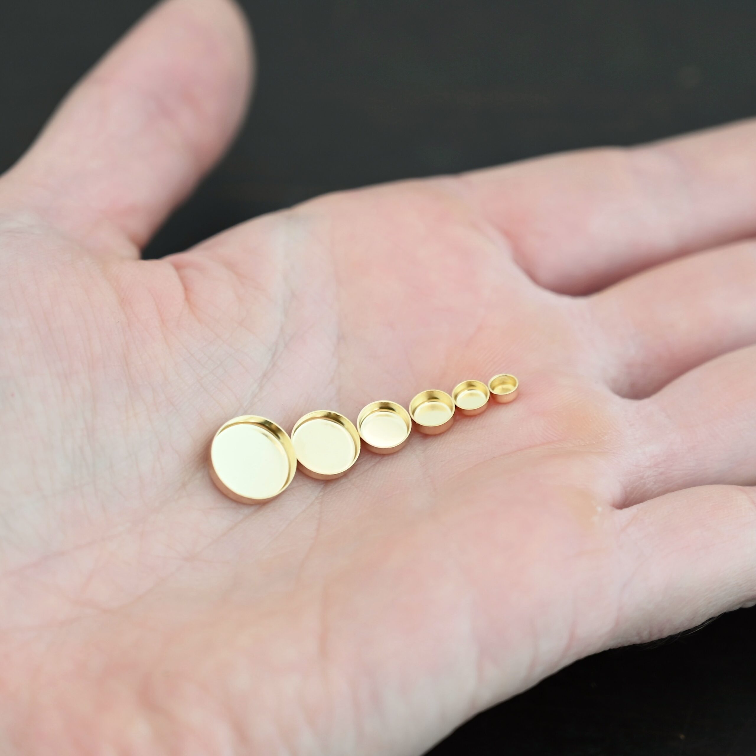 14k gold bezel cups shown in hand