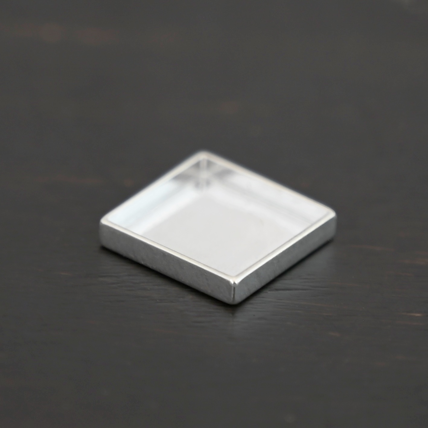 Thick square bezel cups - shiny Thick square bezel cups - shiny shown on dark background