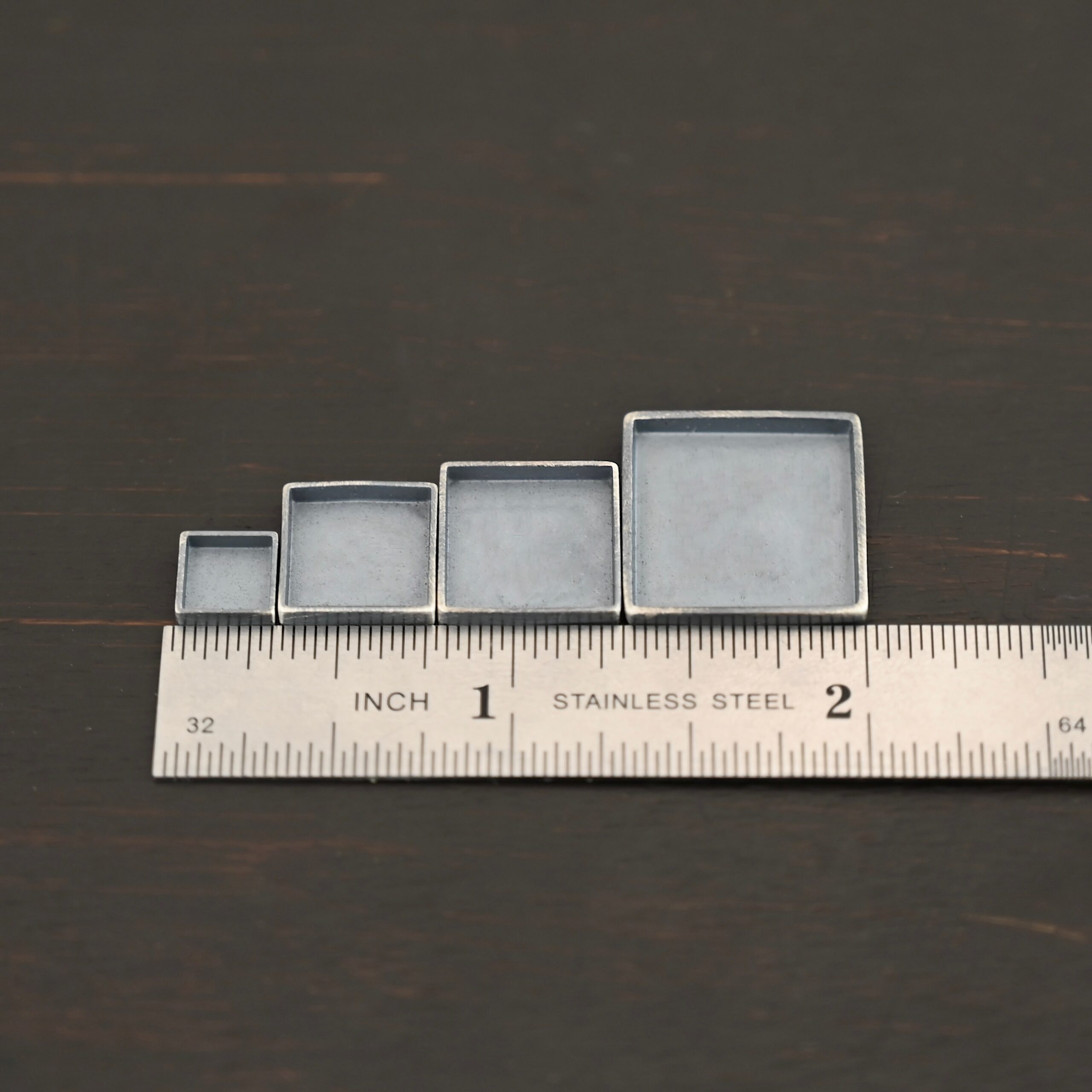 Thick square bezel cups - oxidized Thick square bezel cups - oxidized shown by ruler
