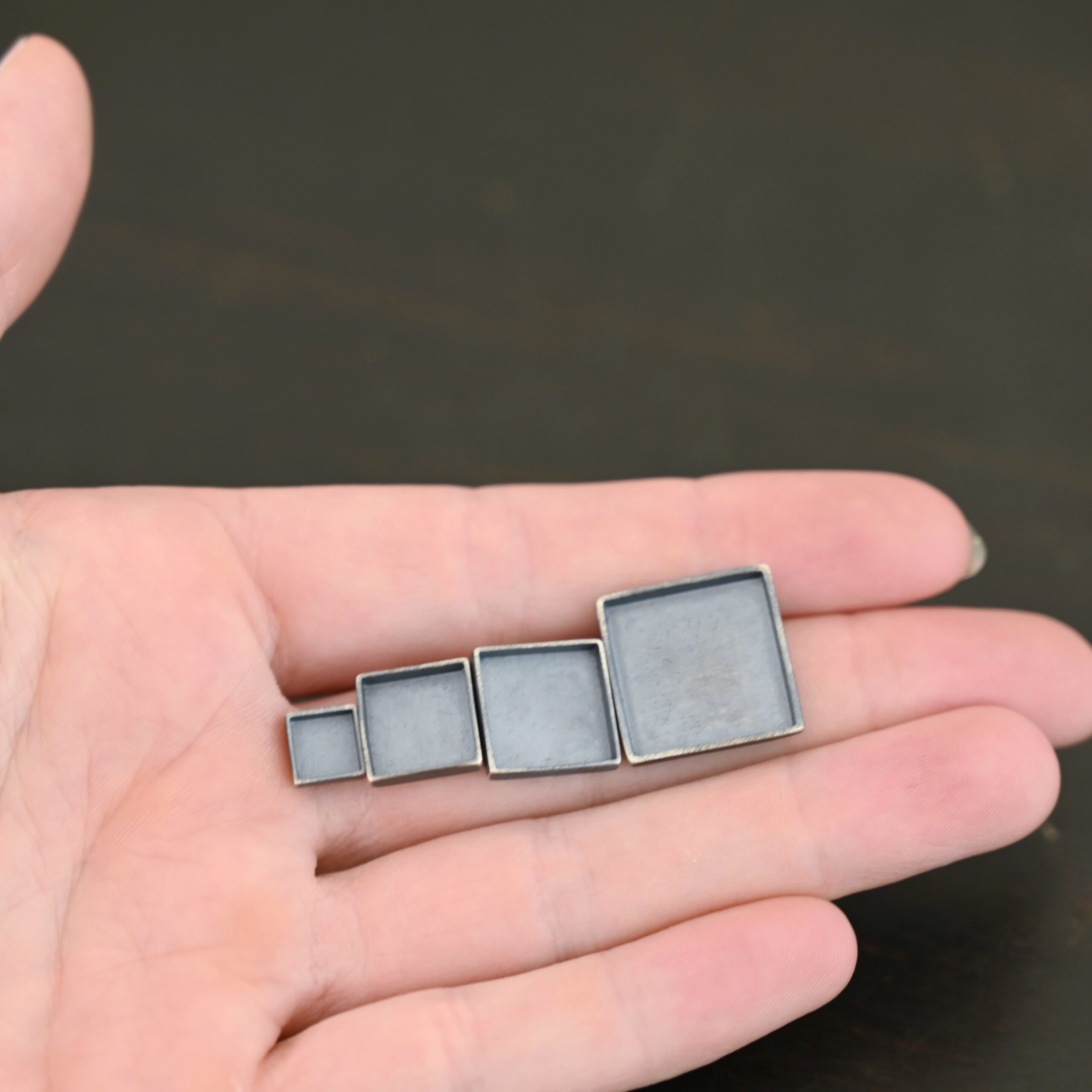 Thick square bezel cups - oxidized Thick square bezel cups - oxidized shown in hand