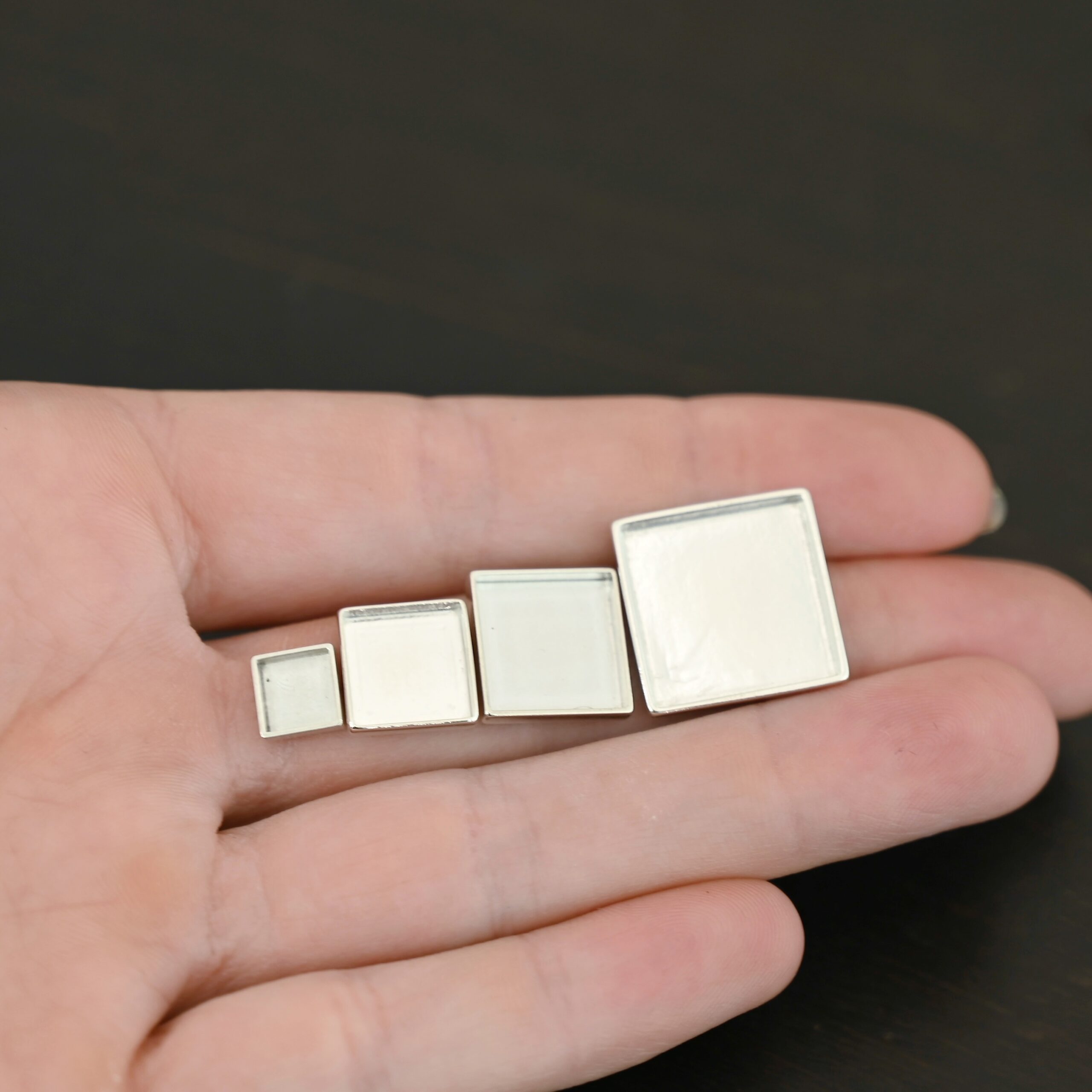 Thick square bezel cups - shiny Thick square bezel cups - shiny shown in hand