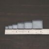 square bezel cups - oxidized shown by ruler
