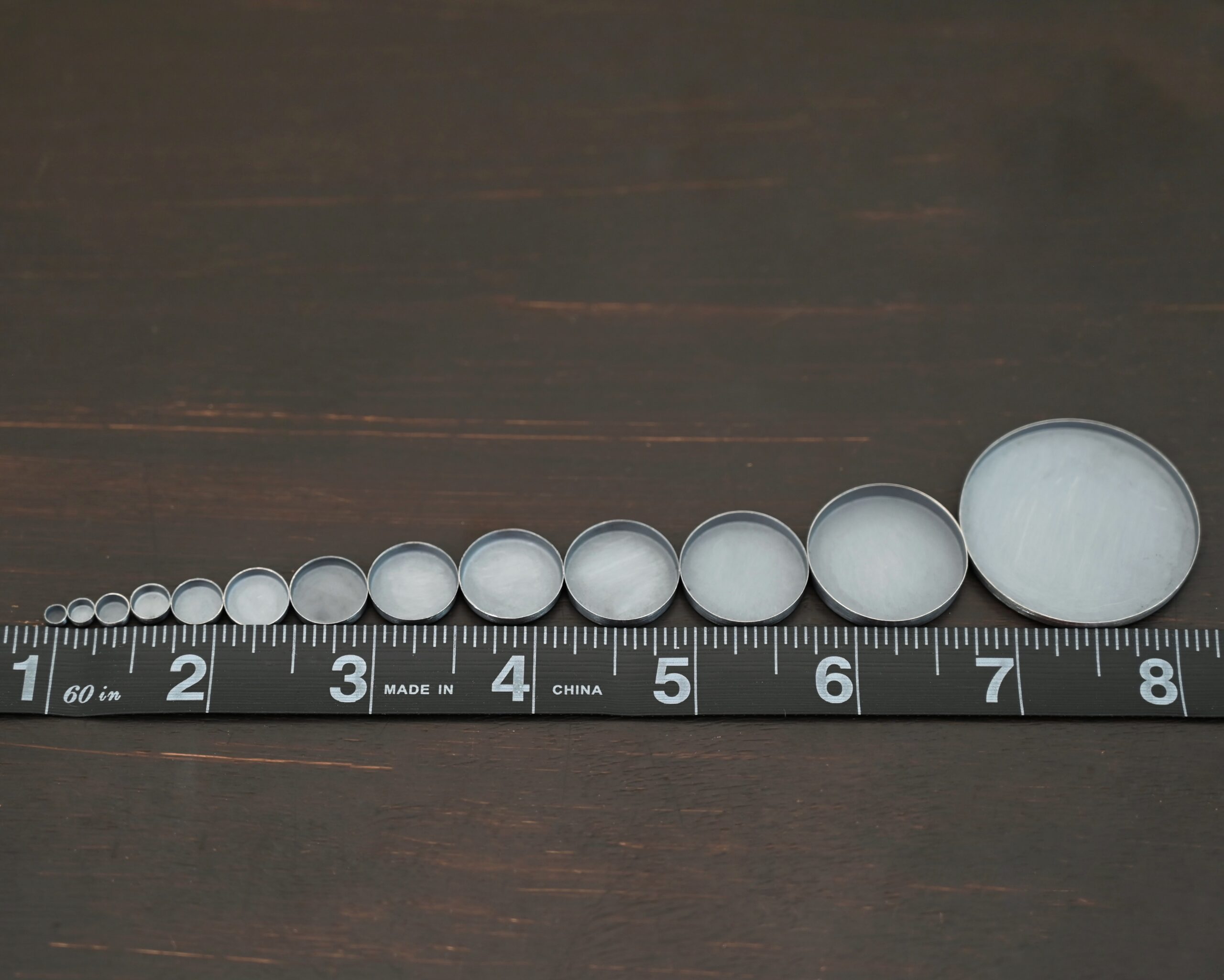 Round Bezel Cups - Oxidized shown by ruler