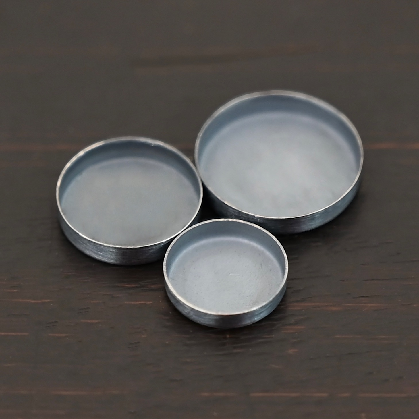 Round Bezel Cups - Oxidized shown on dark background