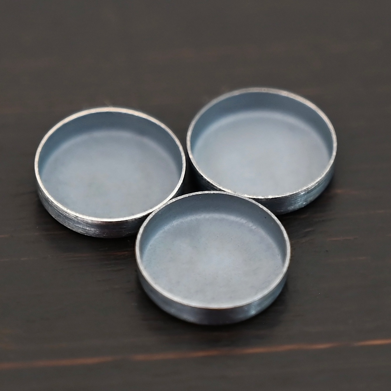 Round Bezel Cups - Oxidized shown on dark background