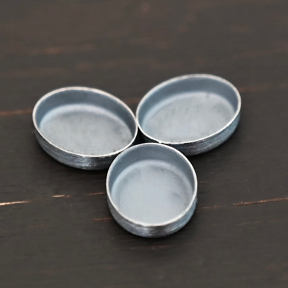 Oval Bezel Cups - oxidized shown on dark background