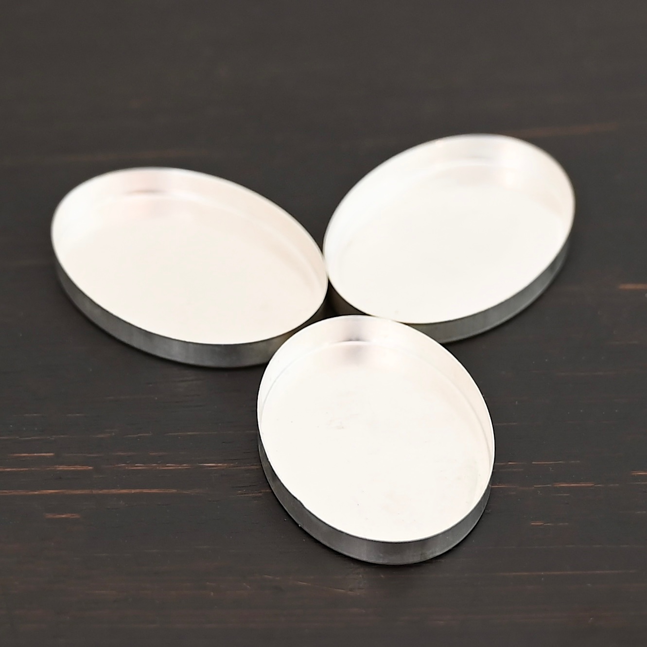 Oval Bezel Cups - shiny shown on dark background