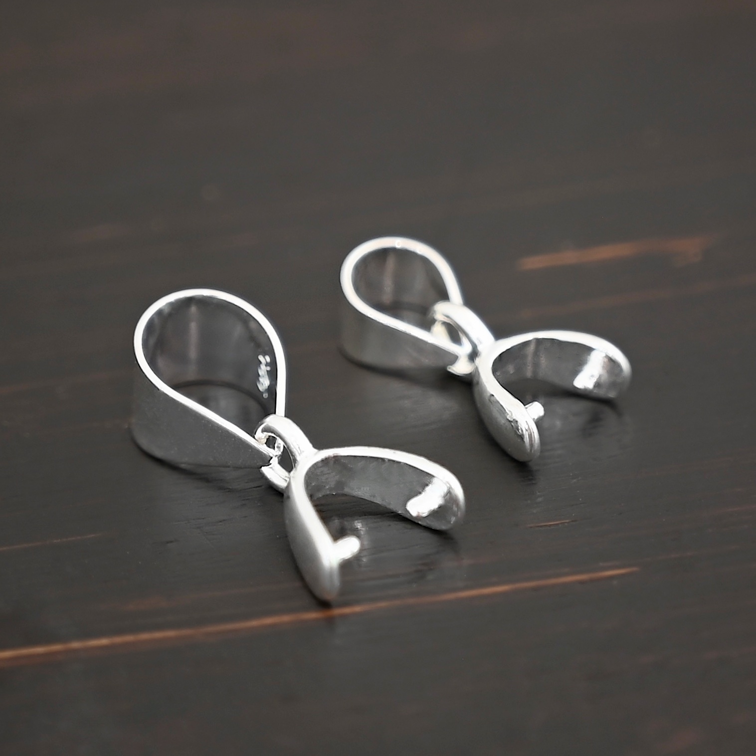 Sterling silver Pinch Bails - shown on dark background