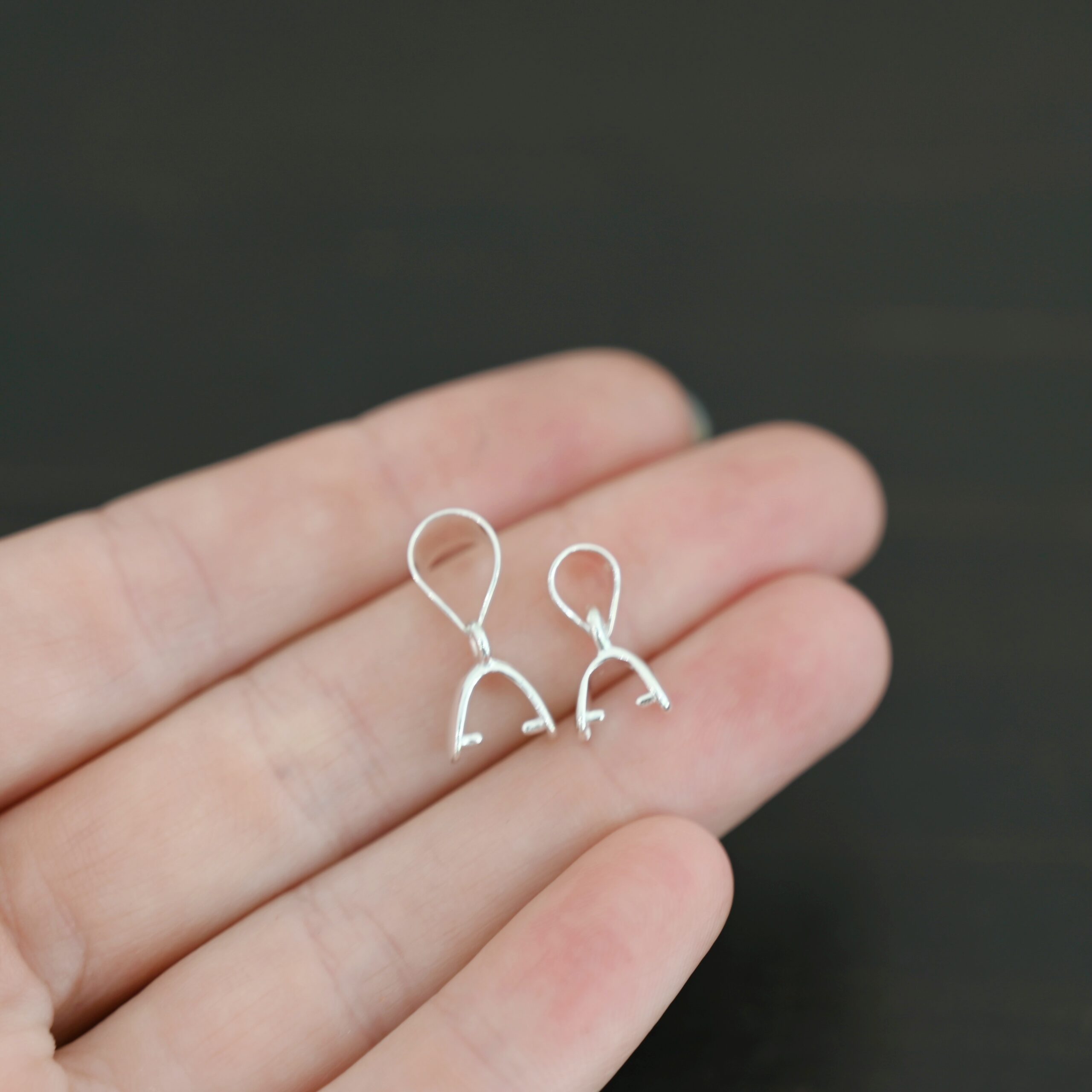 Sterling silver Pinch Bails - shown in hand