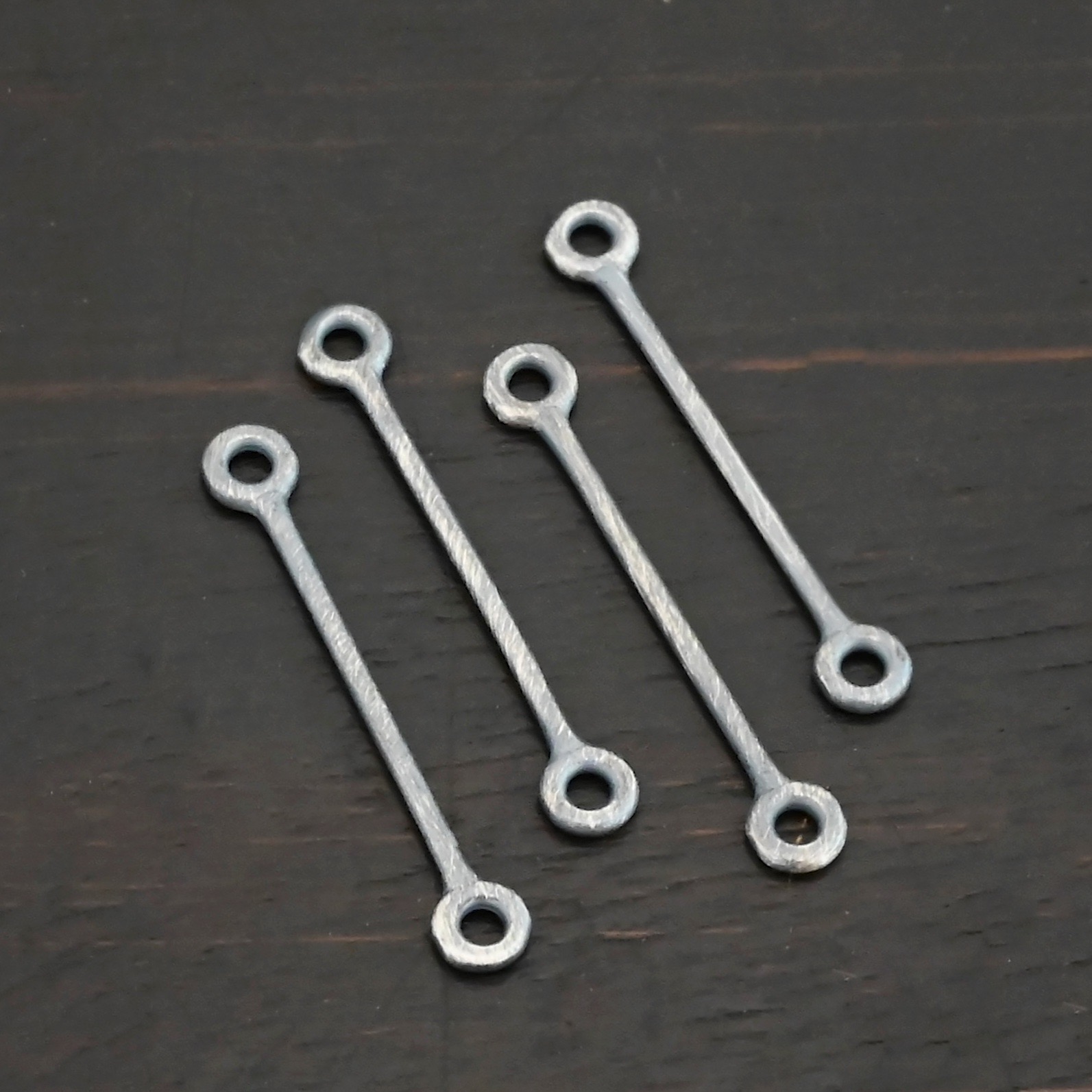 Stick Loop - oxidized Stick Loop - oxidized shown on dark background