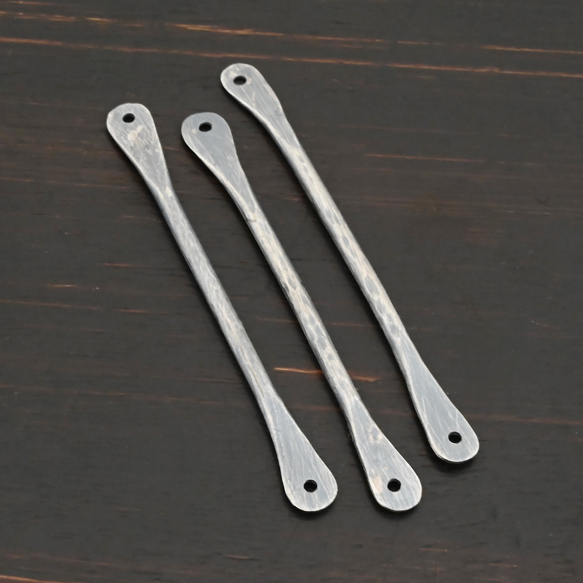 Hammered stick - oxidized shown on dark background