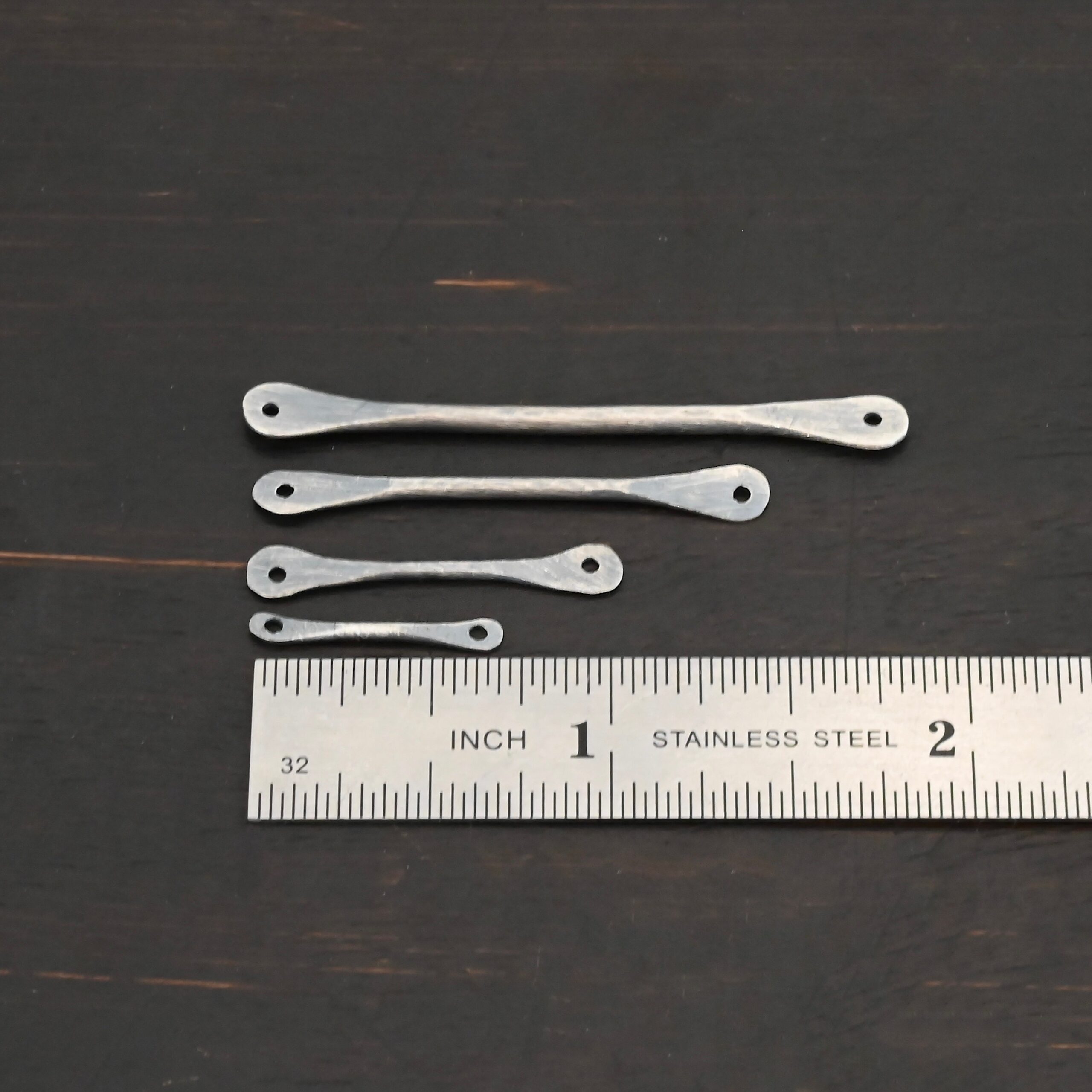 Hammered stick - oxidized shown by ruler