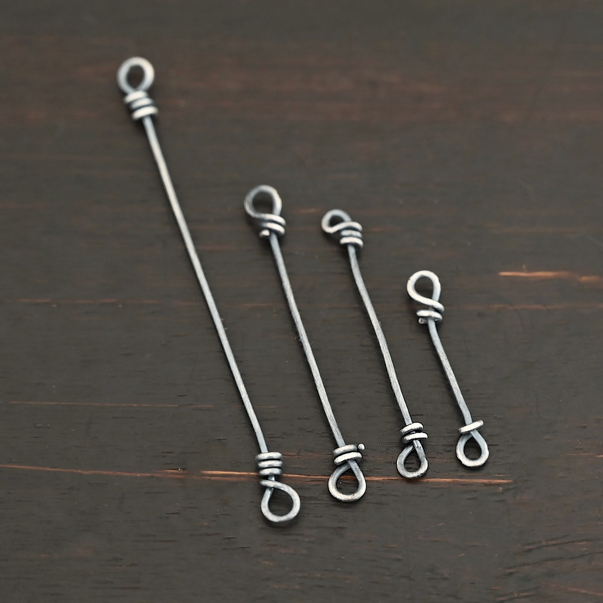 Stick Loop Finding - oxidized Stick Loop Finding - oxidized shown on dark background