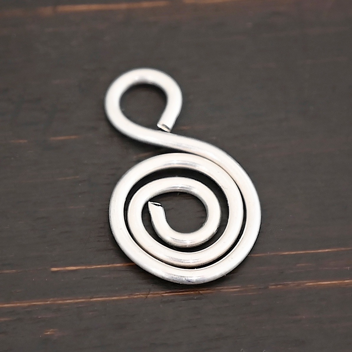 S Shaped Finding - shiny smooth shown on dark background