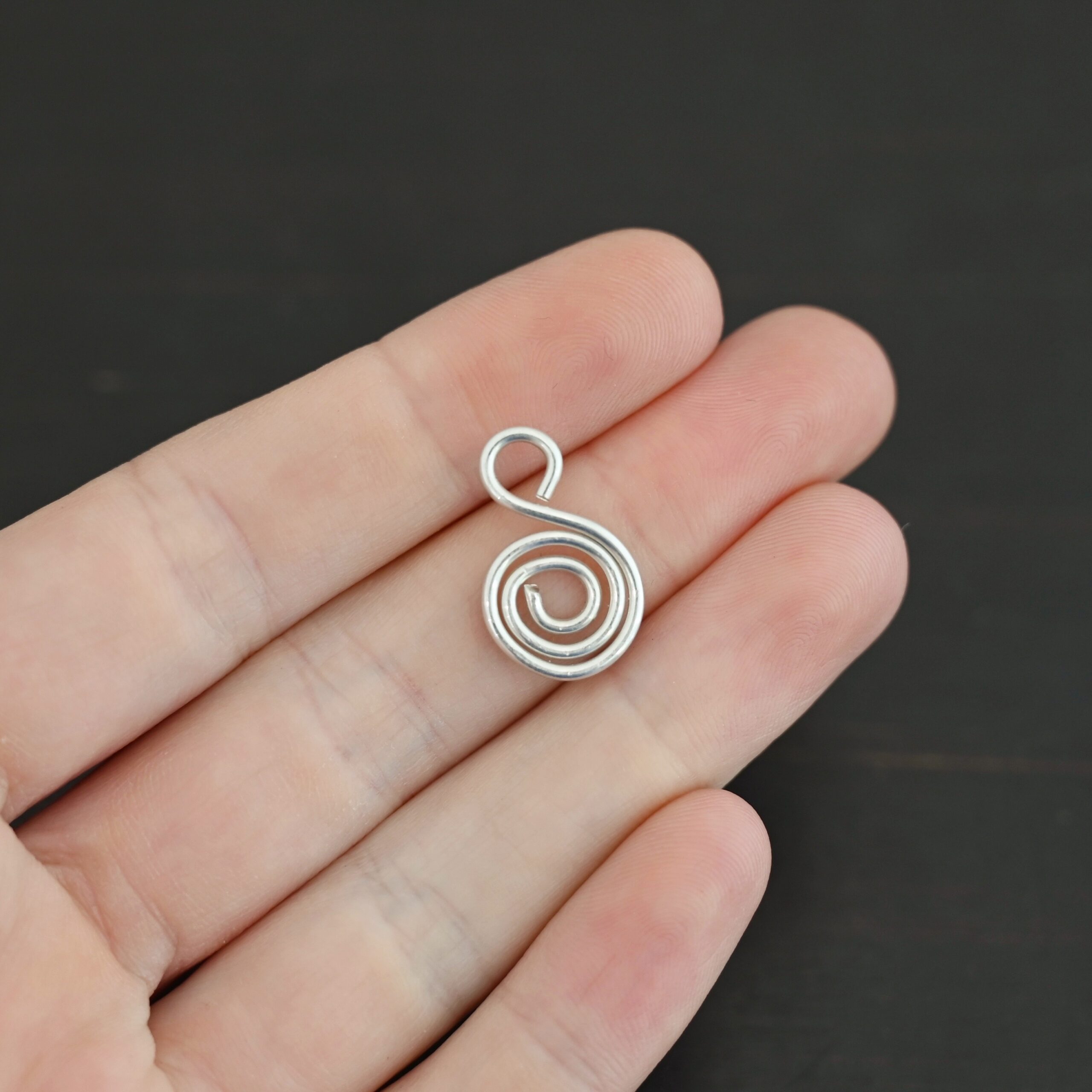 S Shaped Finding - shiny smooth shown in hand