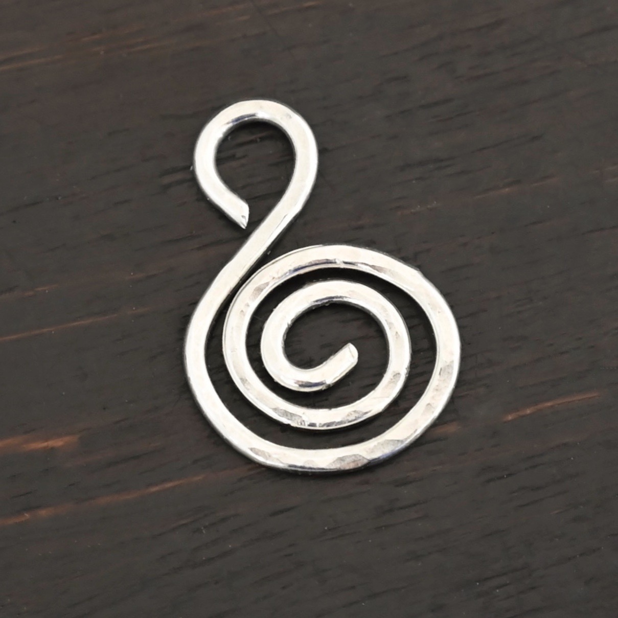 S Shaped Finding - shiny hammered shown on dark background