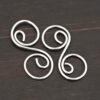 Paired S Shaped Finding - shiny smooth shown on dark background