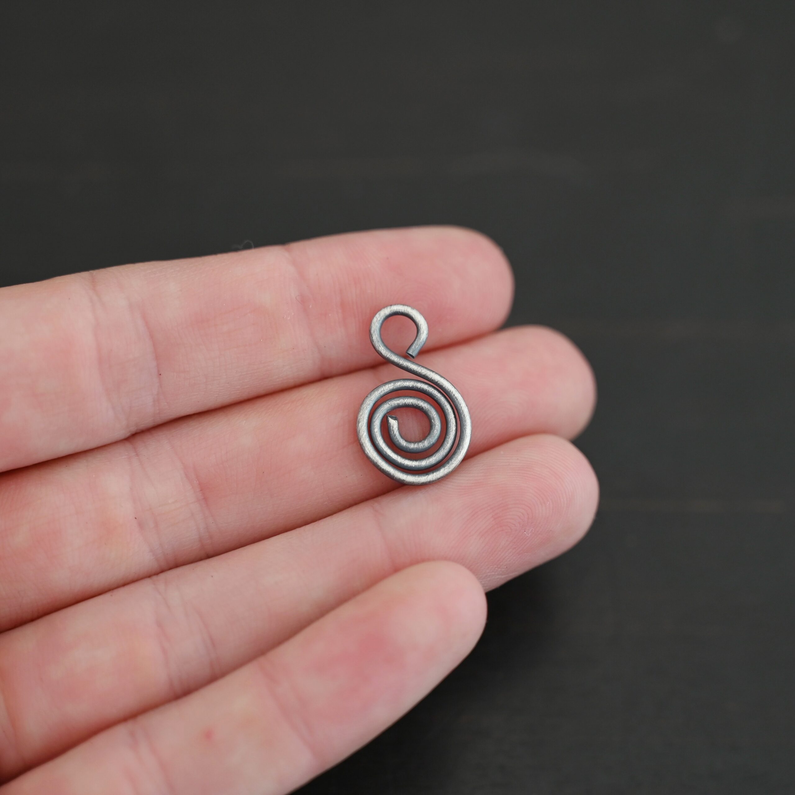 S Shaped Finding - oxidized smooth shown in hand