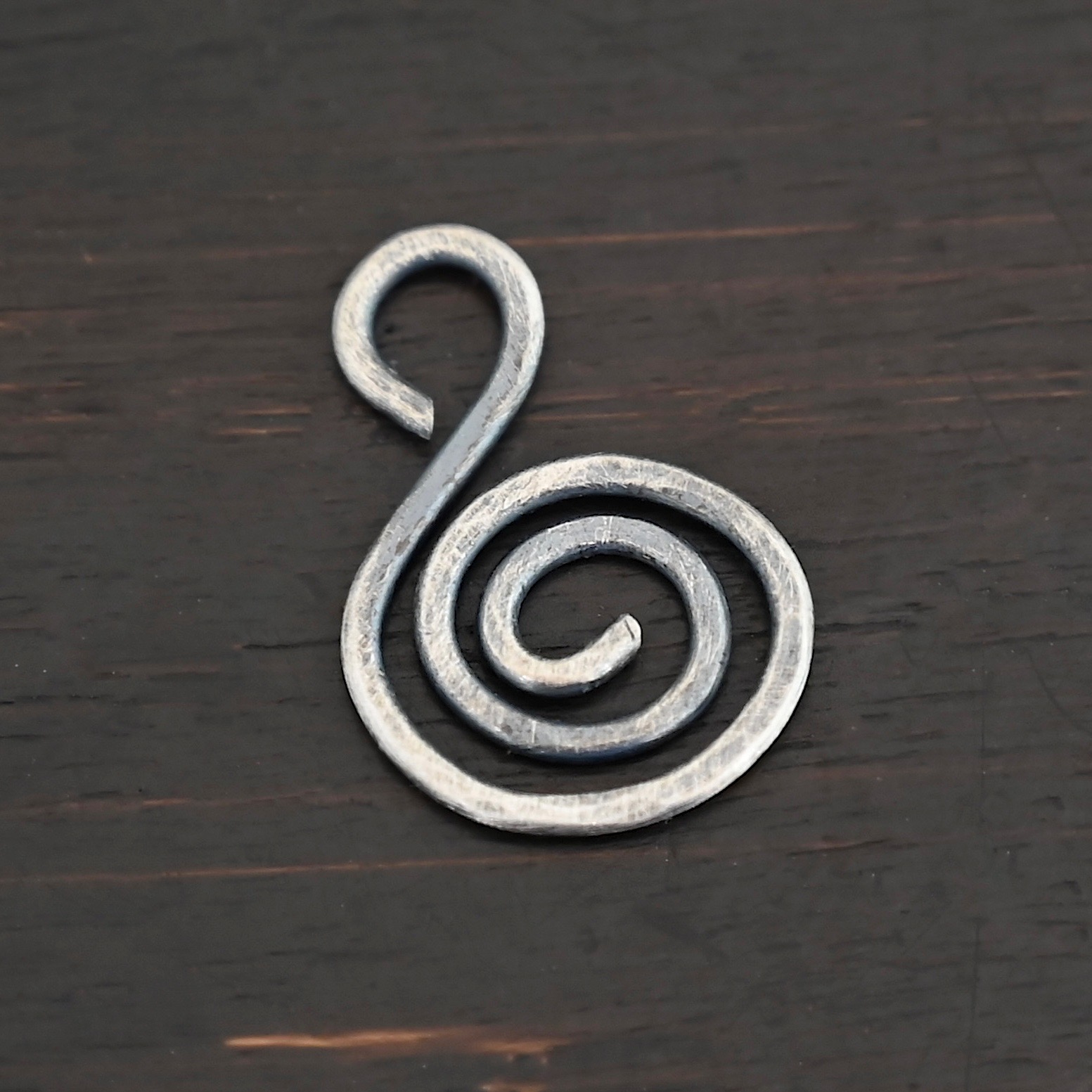 S Shaped Finding - oxidized hammered shown on dark background