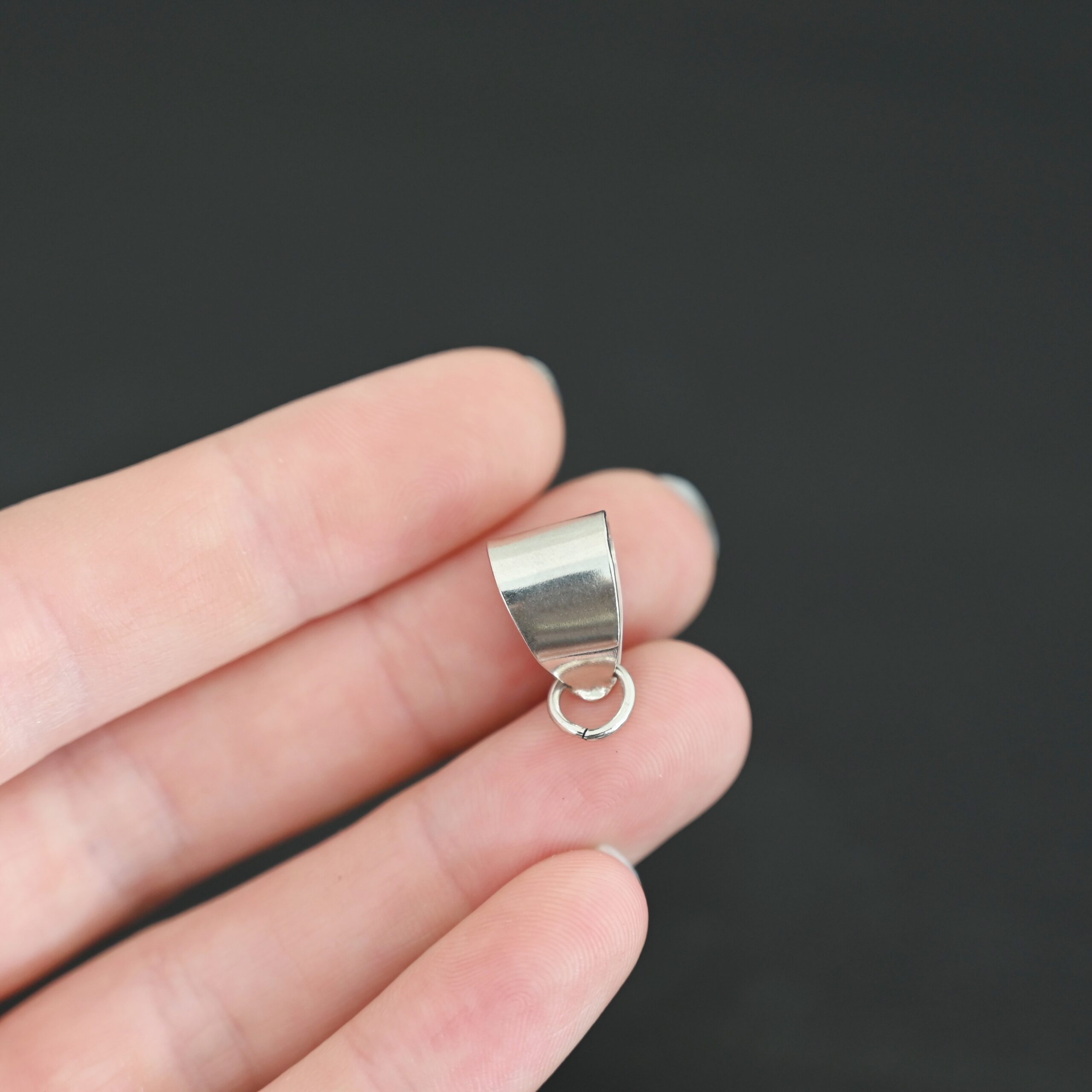 Handmade Pinch Bail - shiny open jump ring shown in hand